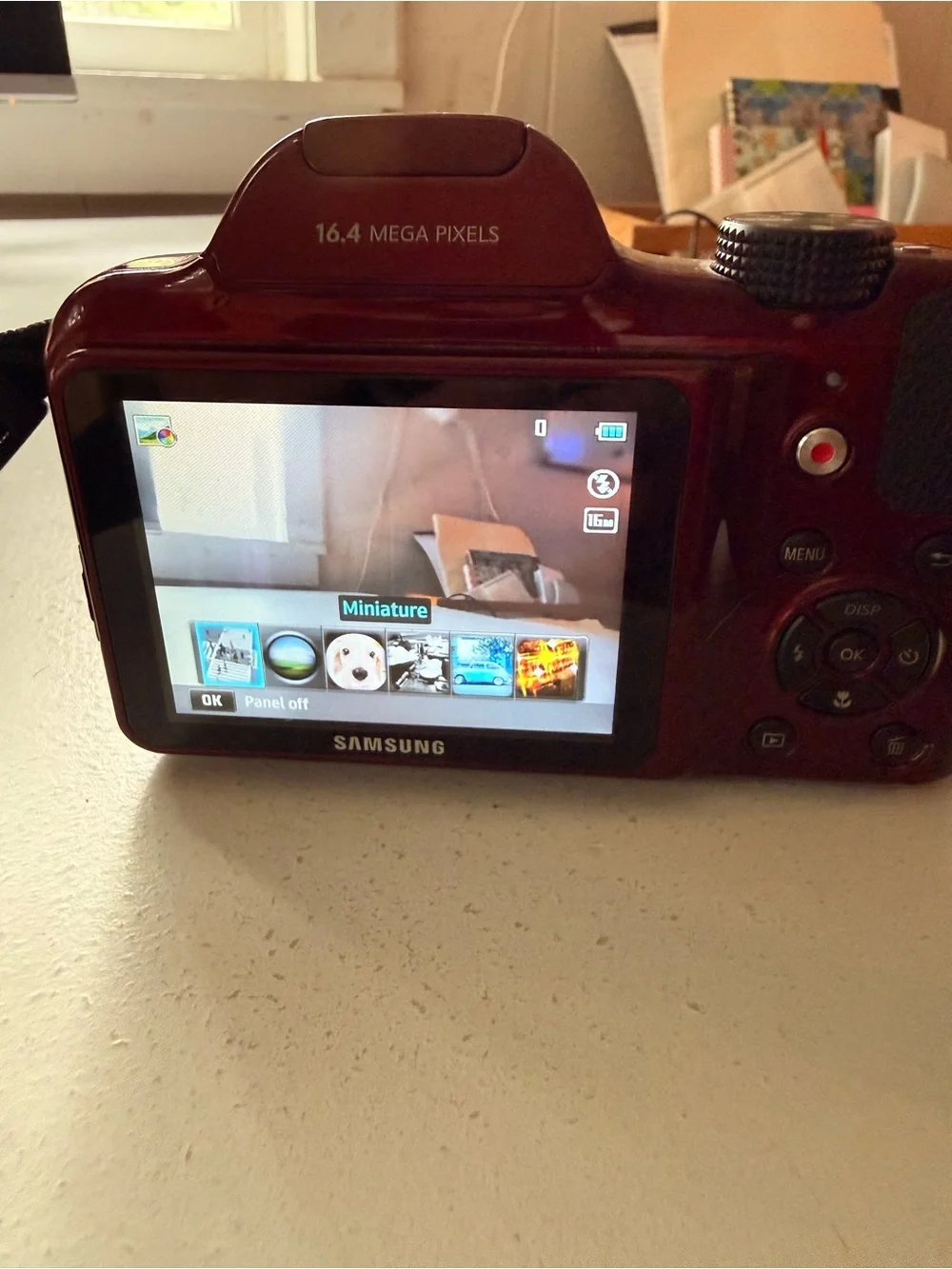 Samsung glossy red digital bridge camera with Samsung lens